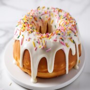 funfetti bundt cake topped with cream cheese frosting